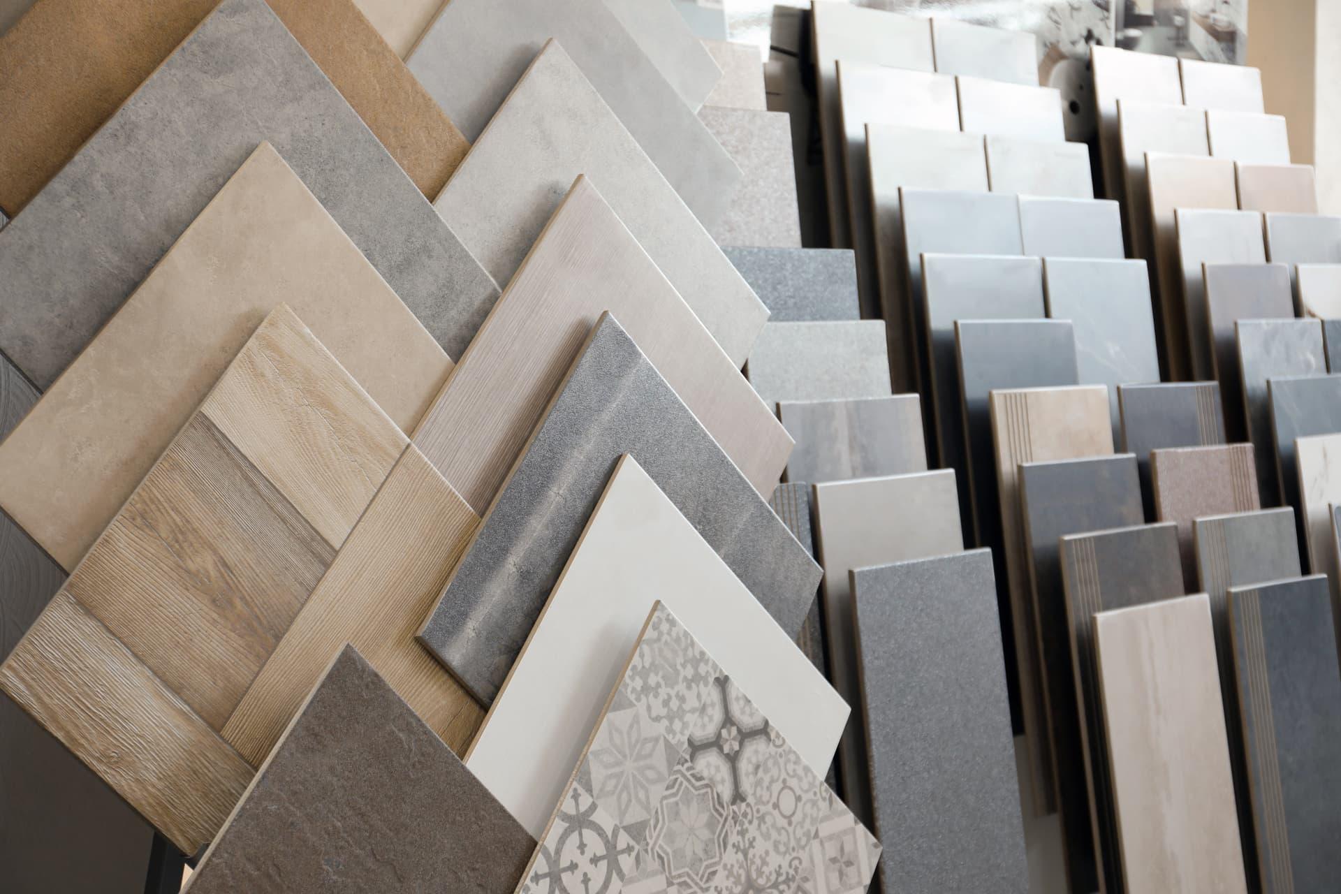 Rows of stone-look and wood-look tile samples in grey and beige