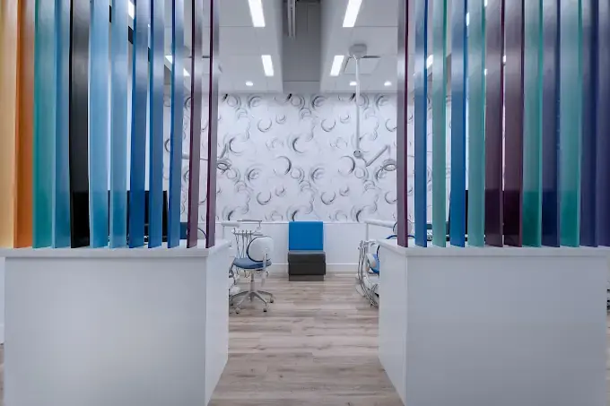 Dental clinic renovation with colourful partitions between treatment bays in Calgary