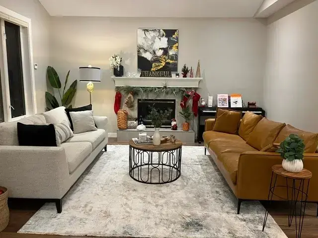 Living room after renovation with updated fireplace and hardwood floors